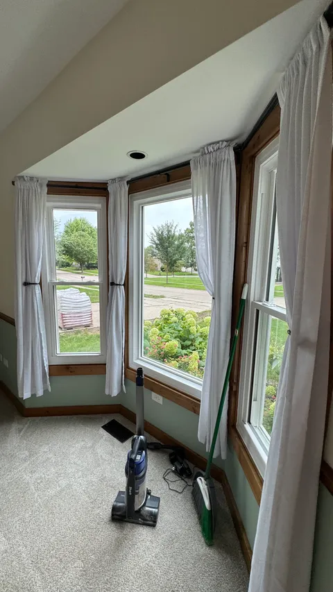 Bay window nook with freshly vacuumed carpet during a whole-home cleaning
