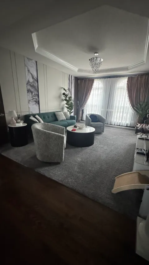 Tidy living room seating area with vacuumed carpet and dusted side tables