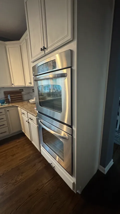 Polished stainless steel double wall oven after a deep kitchen cleaning