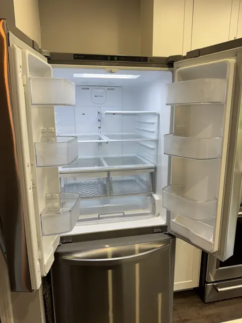 Freshly cleaned refrigerator interior with spotless shelves and drawers